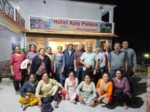 a group of people posing for a picture in front of a building at Hotel Ajay Palace in Pīpalkoti