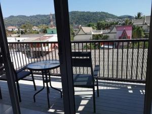 a table and chairs on a balcony with a view at Standard Room in Kata Beach