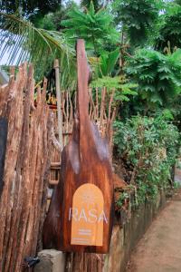 a wooden bag is attached to a wooden fence at Rasa Homestay in Dickwella