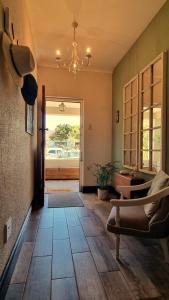 a living room with a couch and a chandelier at Bird Song in Cape Town