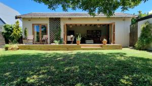 a home with a porch and a patio at Bird Song in Cape Town