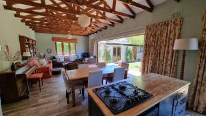 a kitchen and living room with a table and chairs at Bird Song in Cape Town