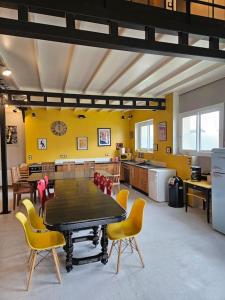 a kitchen with a table and chairs in a room at La salle de jeux in Saint-Lubin-en-Vergonnois