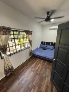 a bedroom with a bed and a ceiling fan at Bagan Serai Simpang Empat Parit Buntar Perak by 3SIBS in Bagan Serai