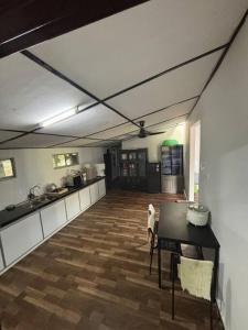 a large kitchen with a table in a room at Bagan Serai Simpang Empat Parit Buntar Perak by 3SIBS in Bagan Serai