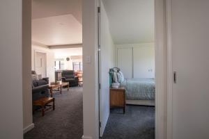 a bedroom with a bed and a living room at Comfort, quality, great location in Hamilton