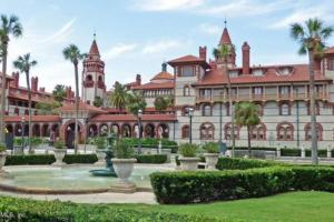 a large building with palm trees in front of it at Modern Sanctuary in Saint Augustine in St. Augustine