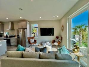 a living room with a couch and a kitchen at Modern Sanctuary in Saint Augustine in St. Augustine