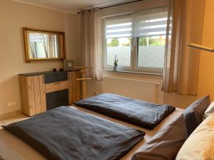 a bedroom with two sleeping bags on a bed at Ferienhaus Amare mit Fasssauna, eigener Terrasse & Kamin in Bautzen