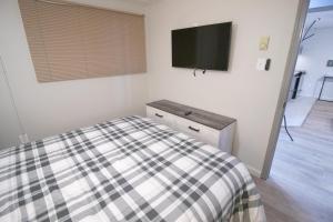 a bedroom with a bed and a tv on the wall at ML245 Skiers Paradise Family Friendly EZ Gated Parking Near Village in Snowshoe