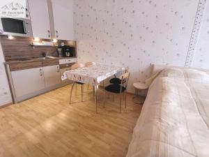 a room with a table and chairs and a bed at Apartment Theresia by FiS - Fun in Styria in Bad Mitterndorf