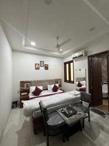 a bedroom with a bed and a table in it at Wellawing Ferozpurn Road in Ludhiana