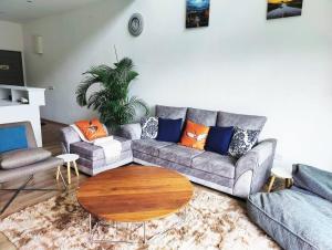 a living room with a couch and a coffee table at #MyLuxeGetaway,Quintet Cameron Highlands in Cameron Highlands