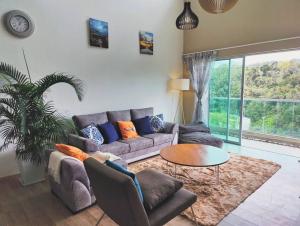 a living room with a couch and a table at #MyLuxeGetaway,Quintet Cameron Highlands in Cameron Highlands