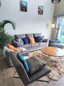 a living room with a couch and a table at #MyLuxeGetaway,Quintet Cameron Highlands in Cameron Highlands