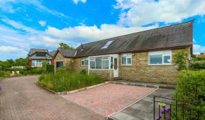 a brick house with a brick driveway at Loft apartment in Accrington Stunning Lancashire views in Church