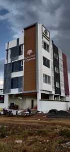 a building with a sign on the side of it at Nandini Executive Lodge in Tuljapur