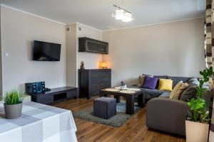 a living room with a couch and a table at Apartament Studio 1c in Władysławowo