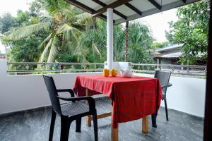 a table with a red table cloth on a balcony at Dream Next in Mirissa