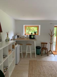 a kitchen with a counter and a table and chairs at Chez Cedric & Emmanuelle in Plonéour-Lanvern