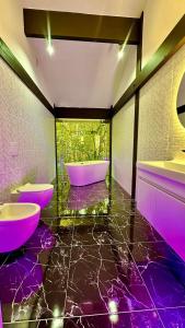 a purple bathroom with two sinks and a tub at Fachwerk Borovoe in Shchūchīnsk