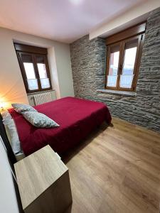 A bed or beds in a room at La Casa del Maestro