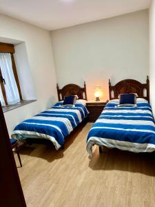 A bed or beds in a room at La Casa del Maestro