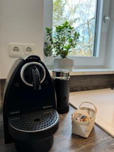 a black toaster sitting on a counter next to a window at WEIDEN51 - Apartment für Business & Familien in Fürstenfeldbruck
