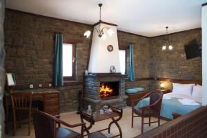 a bedroom with a bed and a fireplace at Seirios Guest House in Nestórion