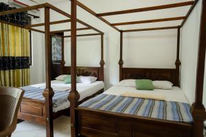 two twin beds in a room with at Dream Next in Mirissa