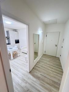 a hallway with a mirror and a living room at Old Town Top Apartment Biella Centro in Biella