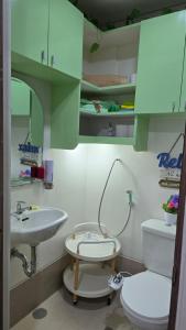 a bathroom with a toilet and a sink at SMDC Spring Resort Residences in Manila +15 photos