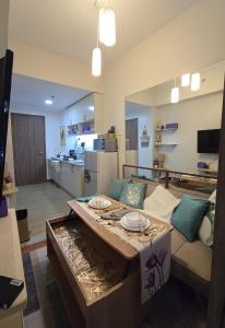 a living room with a couch and a table at SMDC Spring Resort Residences in Manila