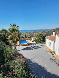 a driveway leading to a house with a swimming pool at Casa los Limones Torrox in Torrox