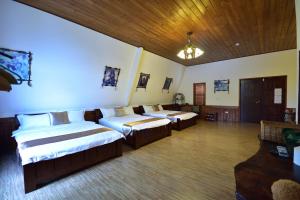 Postel nebo postele na pokoji v ubytování Hou Niao Fei Xing B&B