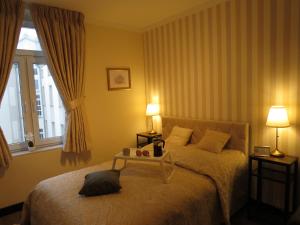 En eller flere senge i et værelse på Polonia Residences 68- Top Locations -Off Piotrkowska Street -Theatres -Museums -Fabryczna Railway Station 3mins