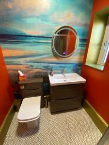 a bathroom with a sink and a mirror at old coastguards station in Wells next the Sea