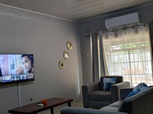 a living room with a couch and a tv at Trio Trails Apartments in Livingstone