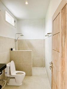 a bathroom with a toilet and a shower at Batur Exotic Villa in Kubupenlokan