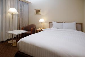 Postel nebo postele na pokoji v ubytování Miyako Hotel Yokkaichi
