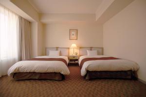 Postel nebo postele na pokoji v ubytování Miyako Hotel Yokkaichi