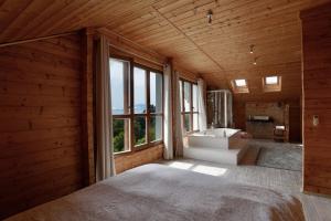 a bedroom with a large window and a tub and a sink at Natural Home Tarifa in Tarifa