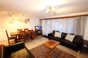 a living room with a couch and a dining room at Sarazena in Saas-Fee