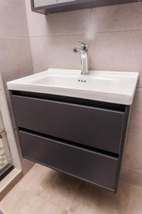 a sink in a bathroom with a white sink at Bole Suites in Lilongwe