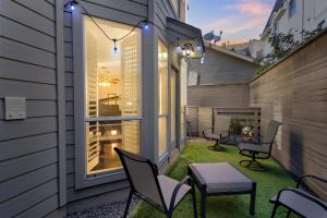 a small patio with chairs and a table and lights at Spacious Urban Uptown Retreat townhouse in Dallas