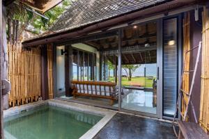 a house with a swimming pool and a bench on a porch at LA A NATU Sam Roi Yot in Sam Roi Yot