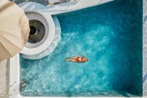 a person swimming in a pool with a roll of toilet paper at Costa Anita Seaside Resort in Guibuangan