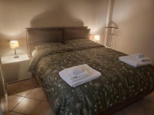 a bedroom with a bed with towels on it at La piccola Flo in Terni +11 photos