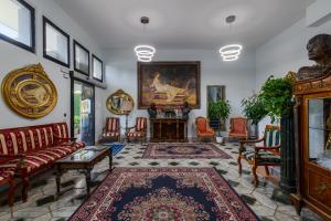 a living room with furniture and a painting on the wall at Hotel Giulietta e Romeo in Casal Palocco