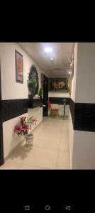 a hallway with a waiting room with flowers on the floor at Frank spaces in Abu Dhabi +4 photos